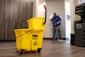 A commercial mop bucket and microfiber mop used by Optimal Prime Cleaning Services