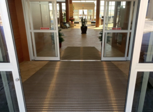 A three-stage walk-off mat system at a commercial building entrance in Sioux Falls