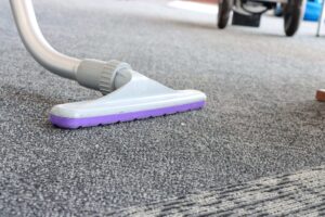 Close-up of a commercial vacuum nozzle on office carpet